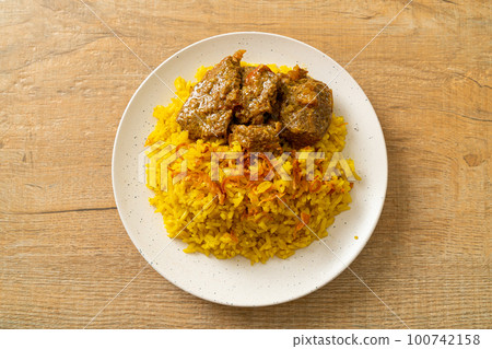 Beef Biryani or Curried rice and beef - Thai-Muslim version of Indian biryani, with fragrant yellow rice and beef 100742158