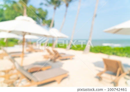 abstract blur umbrella with beach chair for background abstract blur umbrella with beach chair for background 100742461