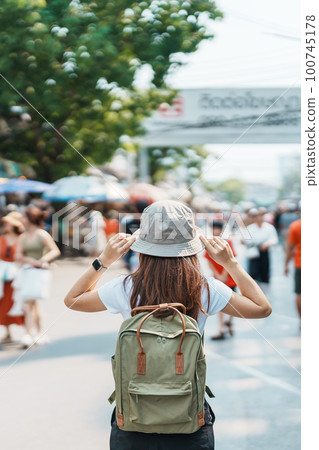 woman traveler visiting in Bangkok, Tourist with backpack and hat sightseeing in Chatuchak Weekend Market, landmark and popular attractions in Bangkok, Thailand. Travel in Southeast Asia concept woman traveler visiting in Bangkok, Tourist with backpack and hat sightseeing in Chatuchak Weekend Market, landmark and popular attractions in Bangkok, Thailand. Travel in Southeast Asia concept 100745178
