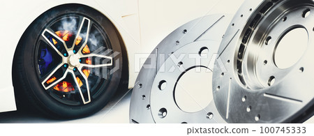 The new metal brake discs of the car and the brake discs burned in the wheels The new metal brake discs of the car and the brake discs burned in the wheels 100745333