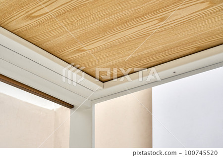 Minimalism style dining table with thin wooden table top of oak veneer on white metal legs in workshop closeup low angle view 100745520