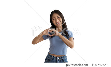 Asian young woman with bright smile making heart symbol shape with hands, Symbol of love and romance, Give each other cuteness and create smiles for each other, Positive thinking concept. 100747842