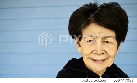 Portrait of an old woman's face who is smiling happily 100747858