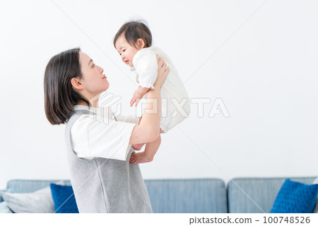 A mother soothing her baby A mother soothing her baby 100748526