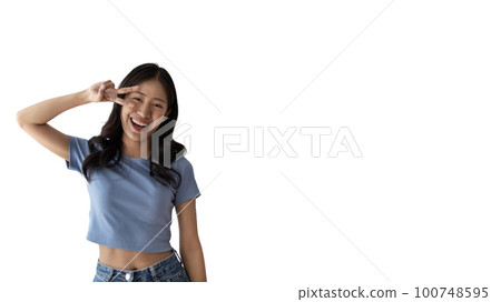 Young Asian woman making two thumbs up gesture showing joy and fun, Symbol of good friendship, Popular photo poses, Make a v-shaped finger, White background. 100748595