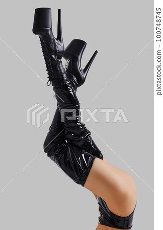 Lifted up female legs in pole dance boots 100748745