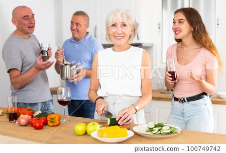 Happy family is preparing a festive dinner in the kitchen Happy family is preparing a festive dinner in the kitchen 100749742