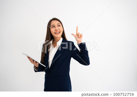 Young beautiful business woman pointing up at copyspace and looking at on pointing over isolated background cheerful with smile on face. Concept of advertising marketing and product placement concept 100752759