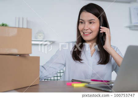 Happy young Asian woman entrepreneur, talk with a supplier and Smile for sale success of online shopping store at home office, Concept of the merchant, small business, online business, and eCommerce. Happy young Asian woman entrepreneur, talk with a supplier and Smile for sale success of online shopping store at home office, Concept of the merchant, small business, online business, and eCommerce. 100753747