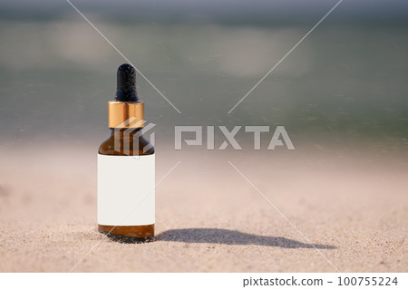 Skincare with beauty cosmetic face serum. Glass brown bottle with a pipette on a natural background with san Skincare with beauty cosmetic face serum. Glass brown bottle with a pipette on a natural background with san 100755224