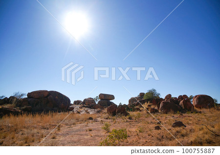 Devil's Marble rock formations illuminated by the setting sun Devil's Marble rock formations illuminated by the setting sun 100755887