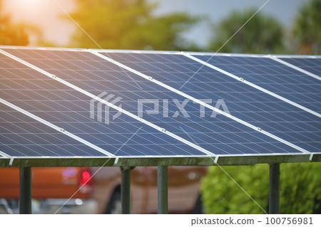 Solar panels installed on stand frame near parking lot for effective generation of clean electricity. Photovoltaic technology integrated in urban infrastructure for electric car charging Solar panels installed on stand frame near parking lot for effective generation of clean electricity. Photovoltaic technology integrated in urban infrastructure for electric car charging 100756981