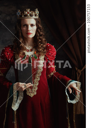 medieval queen in red dress with book and crown medieval queen in red dress with book and crown 100757153