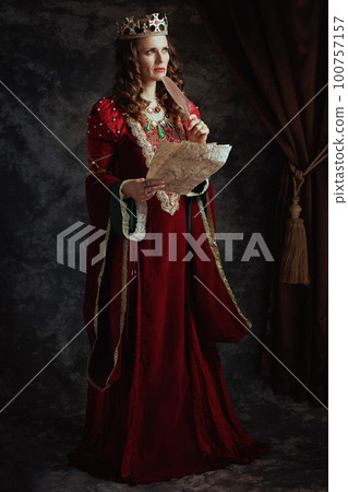 Full length portrait of pensive medieval queen in red dress Full length portrait of pensive medieval queen in red dress 100757157