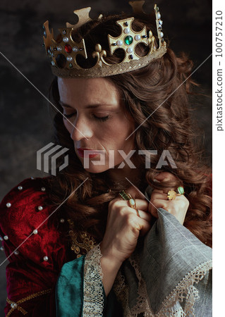 stressed medieval queen in red dress with handkerchief 100757210