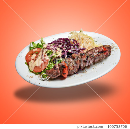 Floating White plate with Lamb skewer and salad 100758706