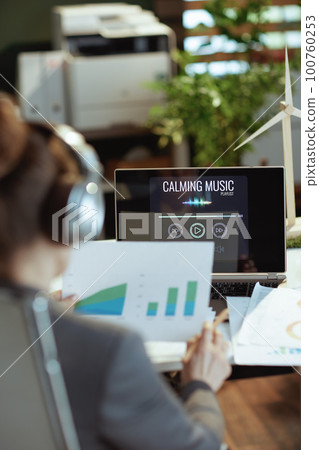Seen from behind female listening to music Seen from behind female listening to music 100760253