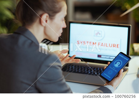 Seen from behind female using call center Seen from behind female using call center 100760256