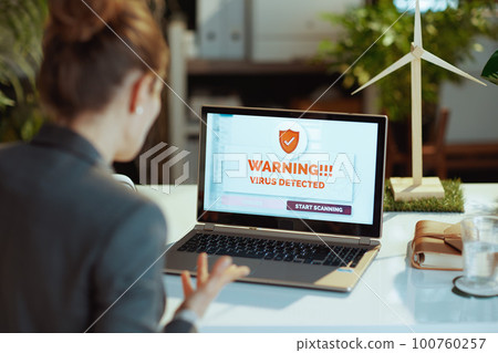 Seen from behind modern woman discovered computer virus Seen from behind modern woman discovered computer virus 100760257