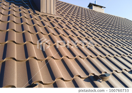Closeup of house roof top covered with metallic shingles 100760733