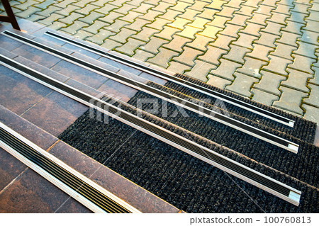 Closeup of ceramic tiles covering porch stairs with rubber anti slippery stripes on it. Closeup of ceramic tiles covering porch stairs with rubber anti slippery stripes on it. 100760813