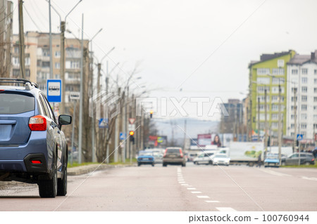 Cars parked in a row on a city street side. 100760944