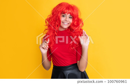 positive teen child with red long hair on yellow background positive teen child with red long hair on yellow background 100760961