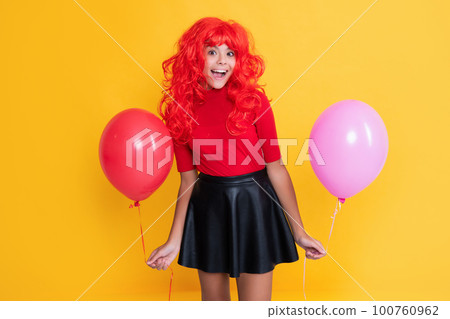 amazed teen kid with party balloon on yellow background amazed teen kid with party balloon on yellow background 100760962