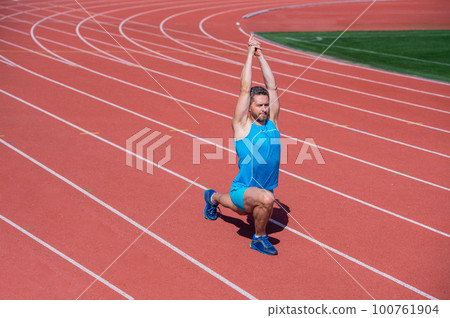 Always in good shape. sportsman flex muscles outdoor. muscular guy do stretching. man in yoga pose. sports and healthy routine. sport success. male athlete do morning exercise. warm up workout 100761904