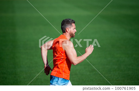 sport and endurance. outdoor stadium sprint. physical training. athletic guy run. 100761905