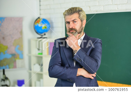 Analyzing strategy. back to school. business school coach. successful in study. get knowledge on lesson. man teacher with dyed beard. bearded man thinking. businessman in suit at blackboard Analyzing strategy. back to school. business school coach. successful in study. get knowledge on lesson. man teacher with dyed beard. bearded man thinking. businessman in suit at blackboard 100761955