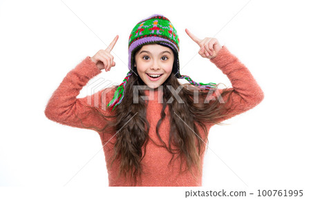 teen girl pointing finger on winter hat isolated on white background. teen girl wear sweater 100761995