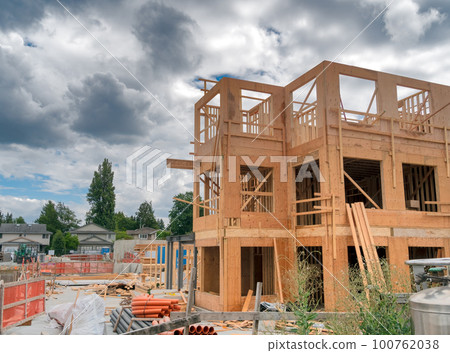 Low-rise residential building under construction on cloudy day 100762038