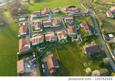 Aerial view of residential houses in green suburban rural area 100762688