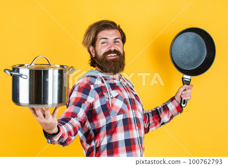 Secret ingredient is joy. Man with saucepan. Man hold new brand pan. Shopping kitchenware. cooking pot in cook man hands in kitchen. food preparation and cuisine. cooking utensils vessels Secret ingredient is joy. Man with saucepan. Man hold new brand pan. Shopping kitchenware. cooking pot in cook man hands in kitchen. food preparation and cuisine. cooking utensils vessels 100762793