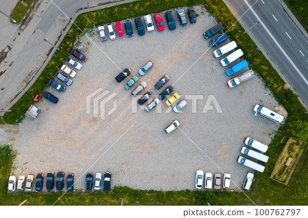 Aerial view of many colorful cars parked on parking lot in evening Aerial view of many colorful cars parked on parking lot in evening 100762797