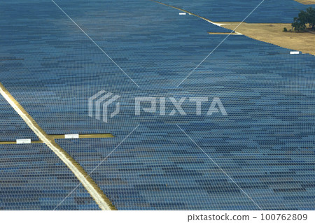 Aerial view of large sustainable electrical power plant with rows of solar photovoltaic panels for producing clean electric energy. Concept of renewable electricity with zero emission 100762809