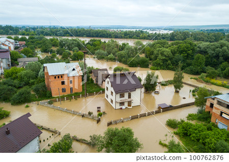 Aerial view of flooded houses with dirty water of Dnister river in Halych town, western Ukraine. Aerial view of flooded houses with dirty water of Dnister river in Halych town, western Ukraine. 100762876