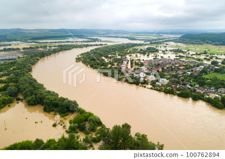 Aerial view of Dnister river with dirty water and flooded houses in Halych town, western Ukraine. Aerial view of Dnister river with dirty water and flooded houses in Halych town, western Ukraine. 100762894