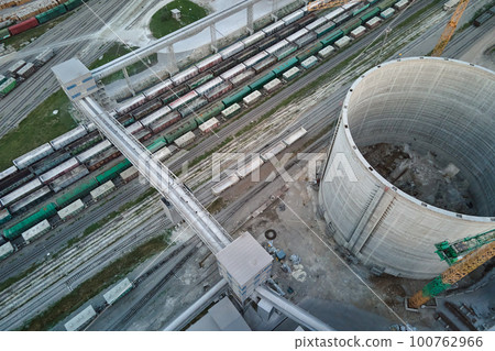 Aerial view of cargo train cars loaded with construction goods at mining factory. Railway transportation of industrial production raw materials Aerial view of cargo train cars loaded with construction goods at mining factory. Railway transportation of industrial production raw materials 100762966