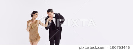 Banner with adorable woman and retro man kissing her hand in vintage evening festive outfits. Concept of love and music, temptation and fashion. 100763446