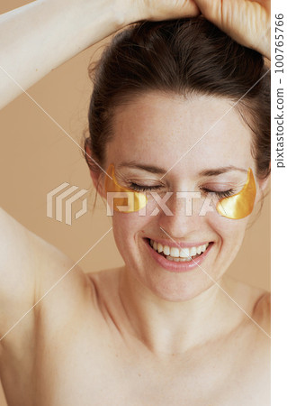 smiling modern woman with eye patches 100765766