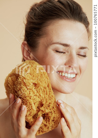 happy modern woman with sea sponge 100765771