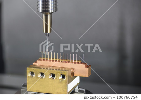 Close up scene the CNC milling machine cutting the copper electrode parts with solid ball end mill. Close up scene the CNC milling machine cutting the copper electrode parts with solid ball end mill. 100766754