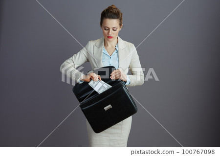 stylish woman worker in light business suit with briefcase stylish woman worker in light business suit with briefcase 100767098