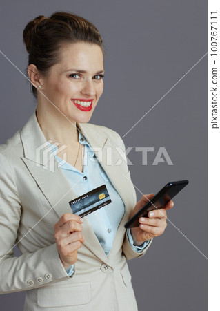 smiling elegant woman worker in light business suit 100767111