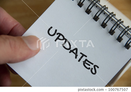 Top view of Update text on white notepad. Business update concept 100767507