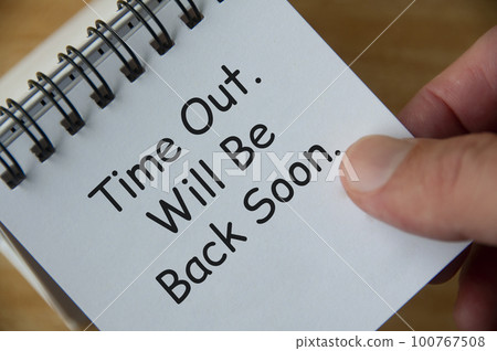 Top view of Time Out. Will Be Back Soon text on white notepad. Business and notification concept. Top view of Time Out. Will Be Back Soon text on white notepad. Business and notification concept. 100767508