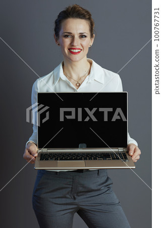 happy business owner woman showing laptop blank screen happy business owner woman showing laptop blank screen 100767731