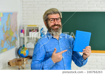 try this one. literature and language learning. strict teacher in glasses. teacher check knowledge. are you ready for exam test. man tutor in classroom. use notebook or book. back to school try this one. literature and language learning. strict teacher in glasses. teacher check knowledge. are you ready for exam test. man tutor in classroom. use notebook or book. back to school 100768263